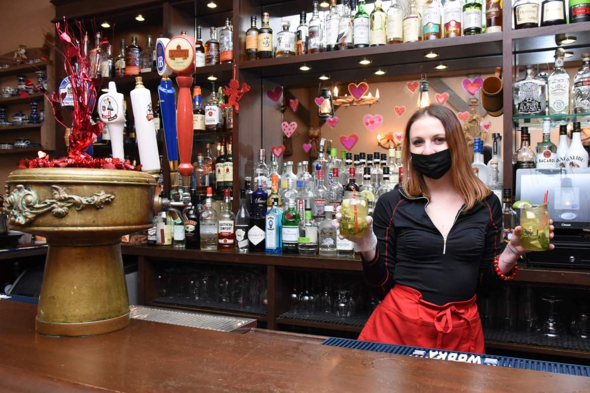 Maja Ruszczyk tends bar at Karczma restauraunt on Friday, Feb. 12, 2021.