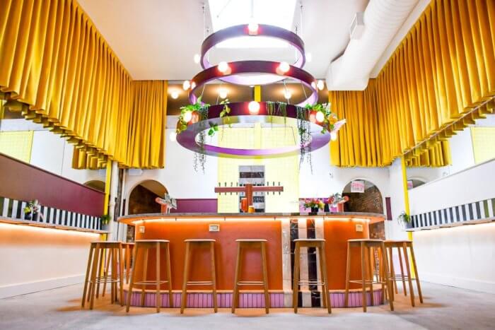 talea taproom in cobble hill with bright colors and lights at bar