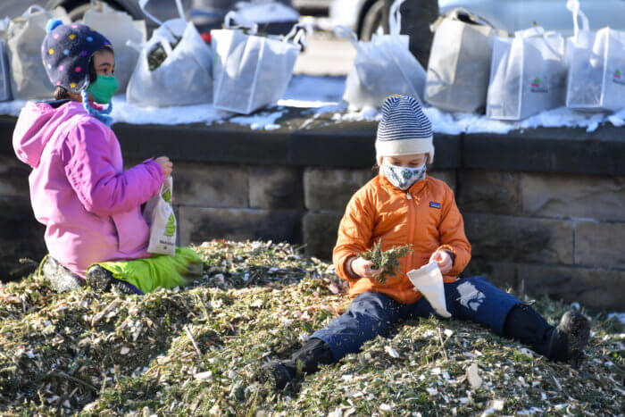 kids sitting on piles of mulch