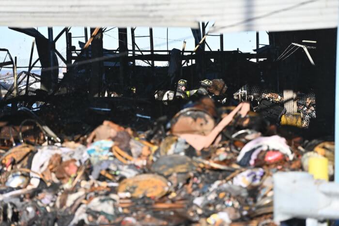 firefighters in rubble of red hook warehouse fire