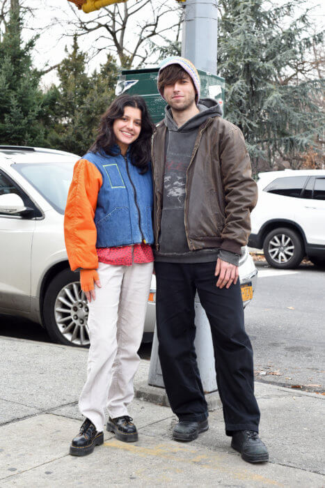 man and woman pose on sidewalk in brooklyn