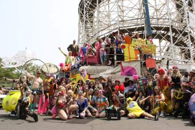 Revelers pose alongside a float at the 41st Annual Mermaid Parade in Coney Island.