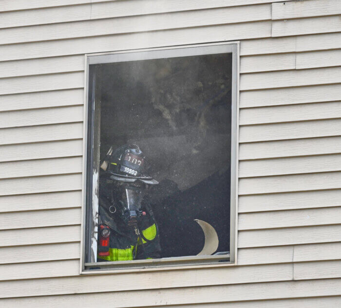 firefighter in window of bath beach home
