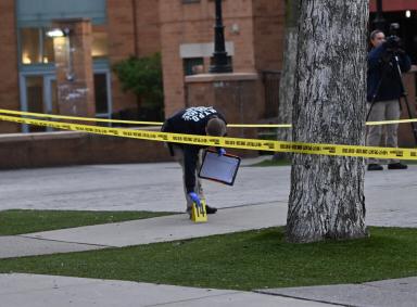 A crime scene detective processes the scene where 31 year old Jason Oliver was fatally shot at 330 Hinsdale St. on April 26, 2023.