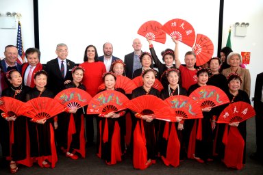 people with red fans for lunar new year