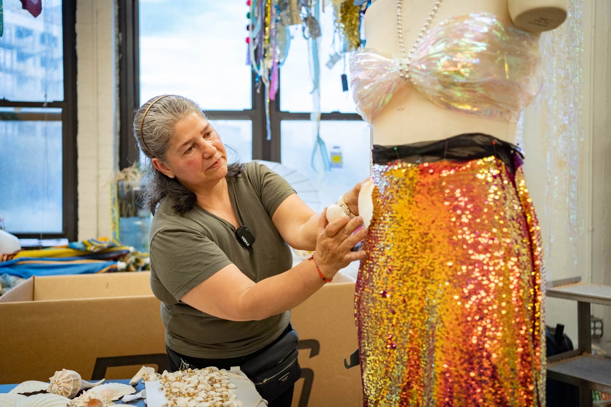 woman at materials for the arts working on mermaid parade dress